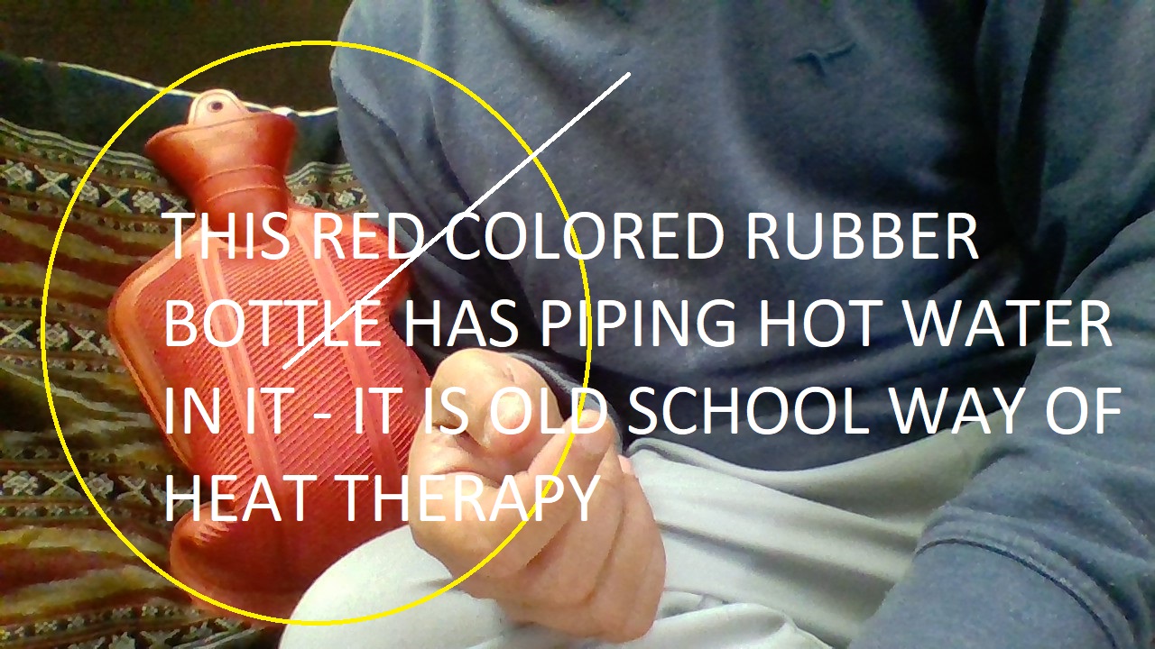 THIS RED COLORED RUBBER BOTTLE HAS PIPING HOT WATER IN IT - IT IS OLD SCHOOL WAY OF HEAT THERAPY